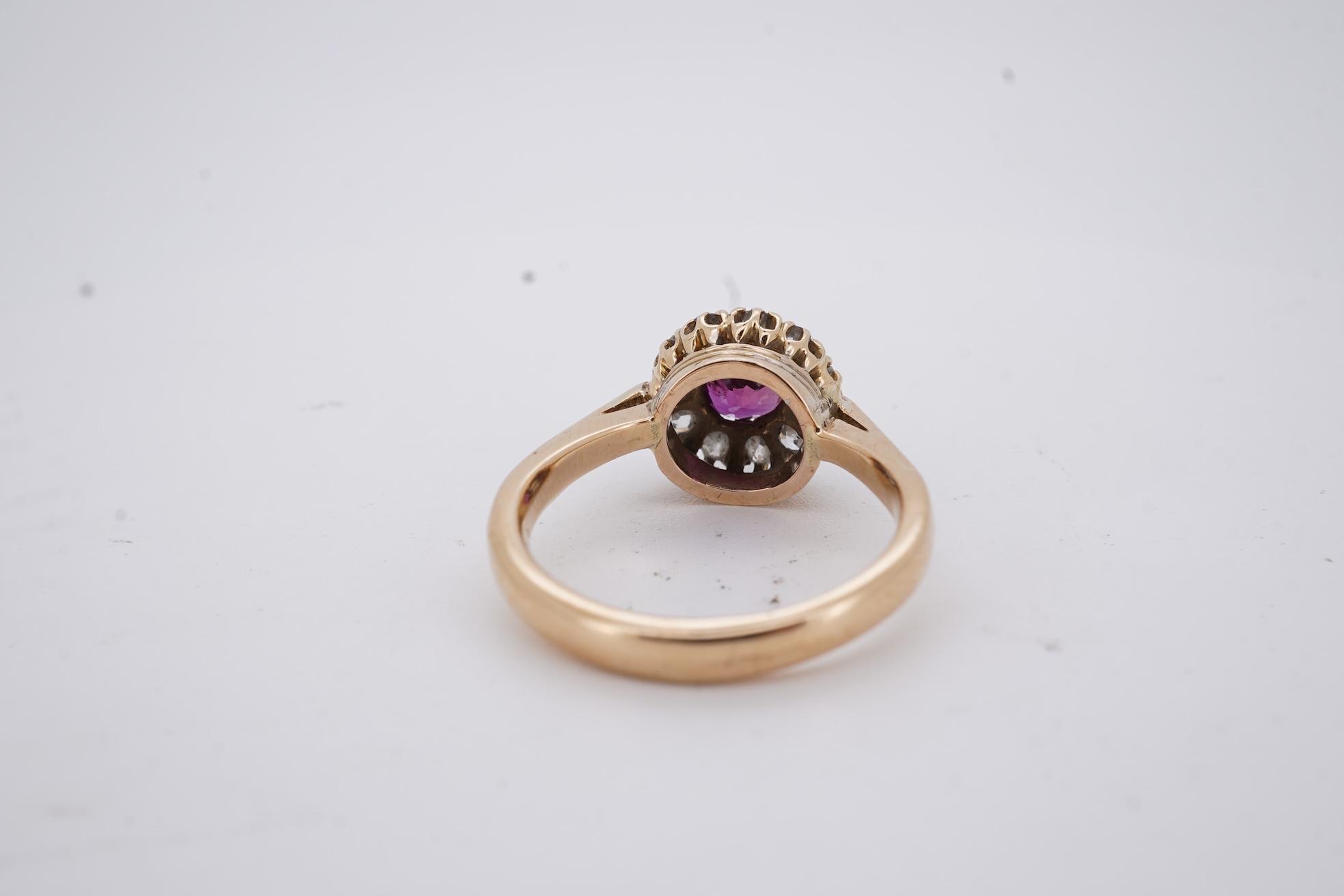 A George V 18ct gold, ruby and diamond set circular cluster ring, size M, gross weight 5 grams.